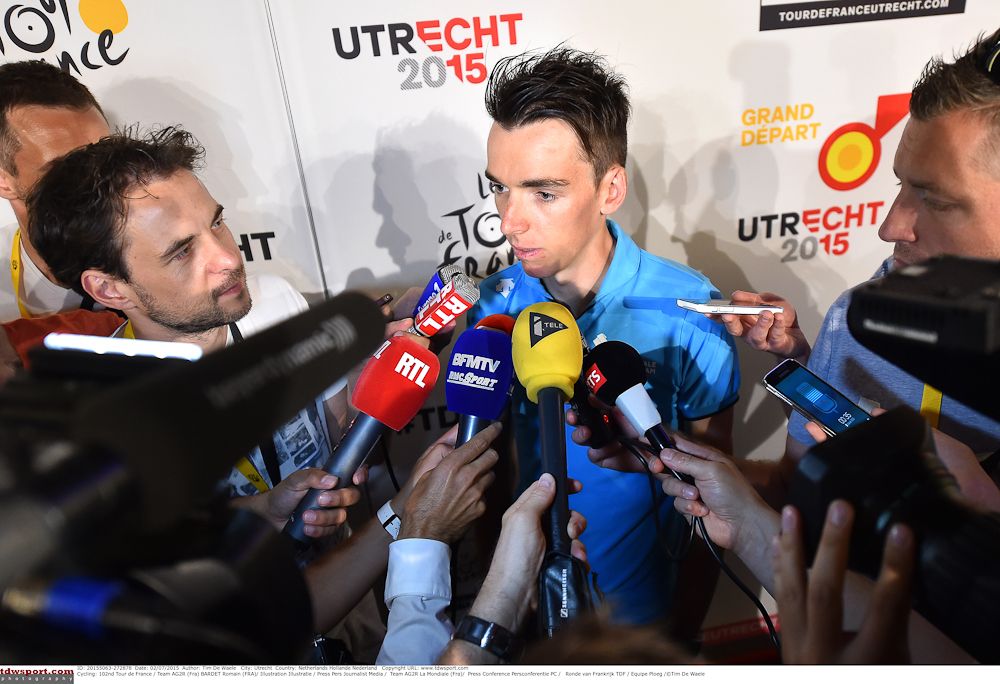 Romain Bardet is surrounded by microphones.