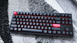 The Keychron Q3 Max gaming keyboard set-up on a desk with the RGB lighting enabled.