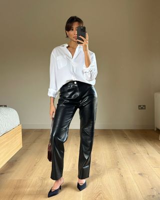 @smythsisters wearing leather trousers and a white shirt