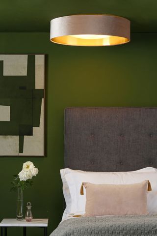 a flush light in a green bedroom scheme