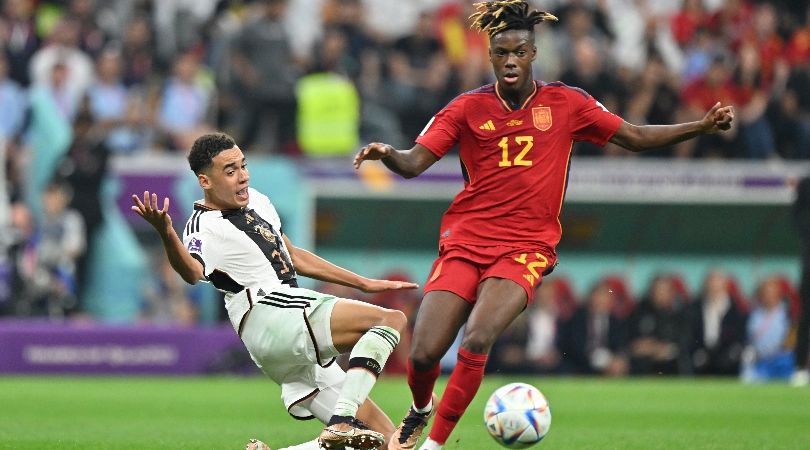 Germany&#039;s Jamal Musiala tackles Spain&#039;s Nico Williams at the 2022 World Cup.