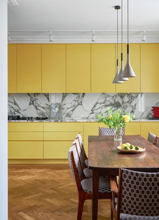 Yellow kitchen with marble splashback