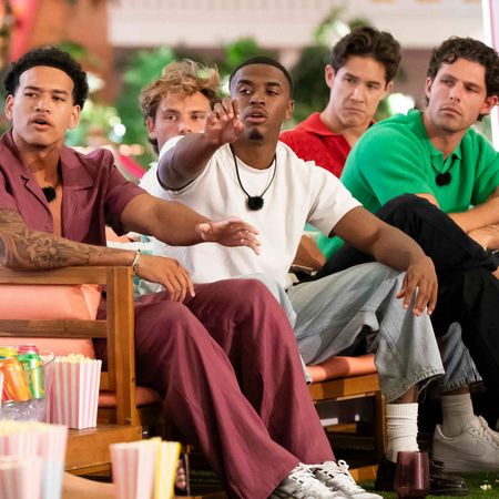 Corbin Mims, Gal Tshnieder, Kuman "KC" Dameon Chandler, Carl Schmidt, Dylan Wrona, and Zacharias Georgiou look shocked sitting on a couch together during movie night on love island usa season 8