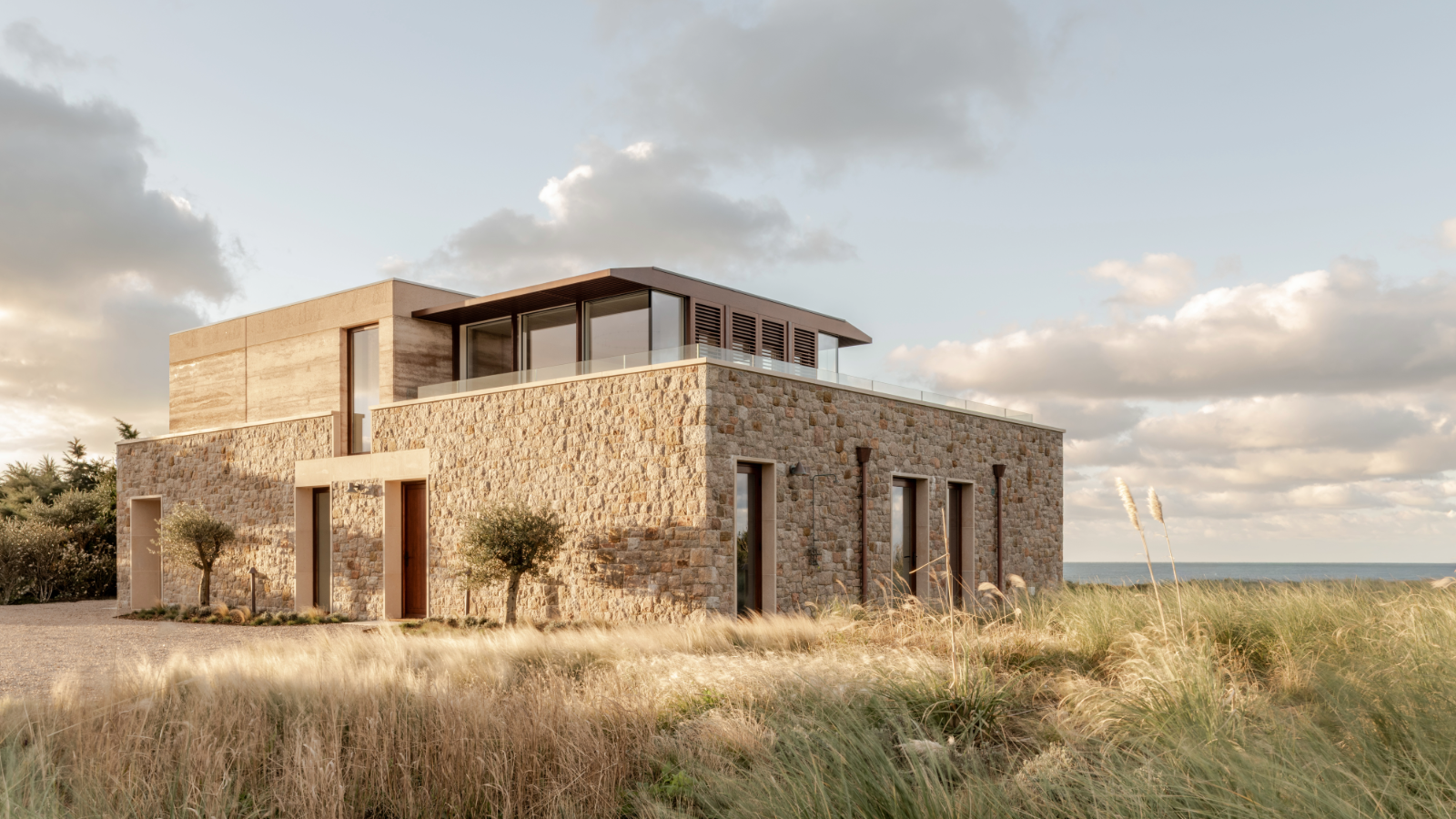 Tour a dreamy beach house on the wild Jersey coast, built of rammed earth