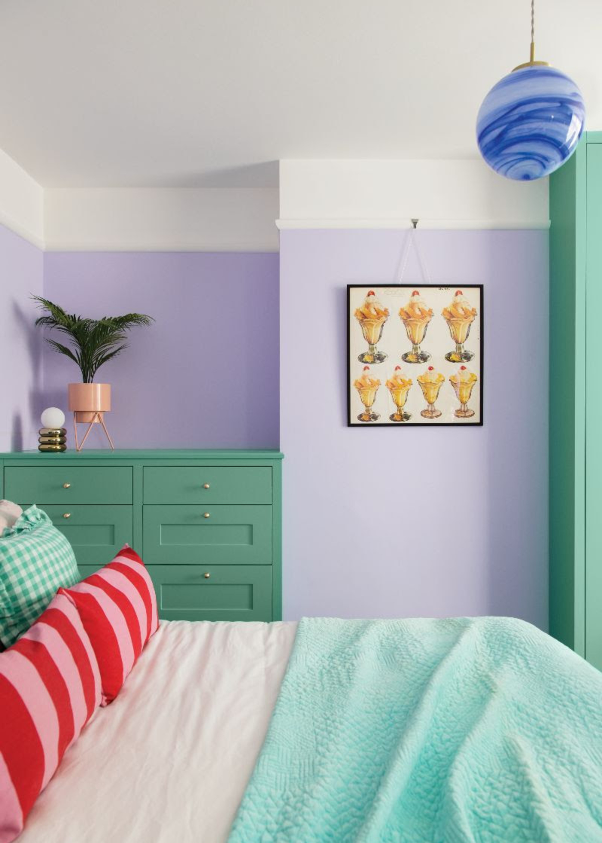 a bedroom with built-in storage in the alcoves with lilac and green color scheme