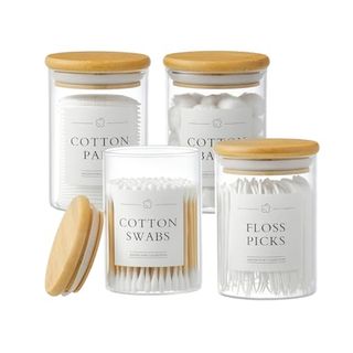 Glass 4 Pack Apothecary Jars With Lids showing cotton swabs, pads, balls and floss picks 