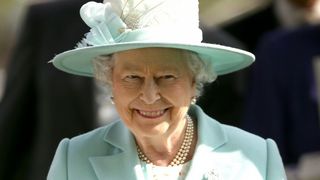 The Queen in a light mint outfit.