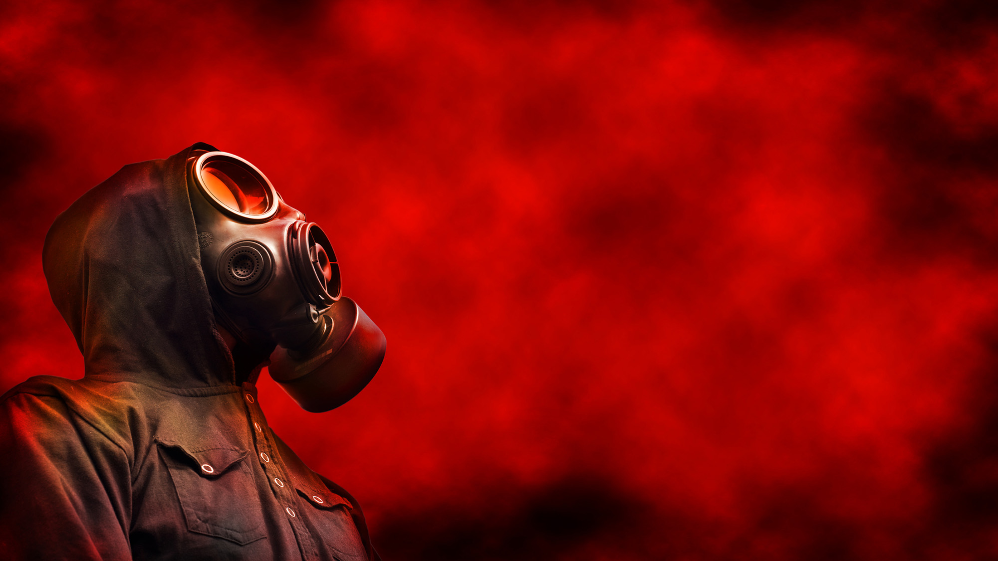 A person wears a gas mask and looks up at the top right image