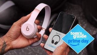 Beats Solo 4 headphones being paired with a phone with a Tom's Guide Prime Day badge added