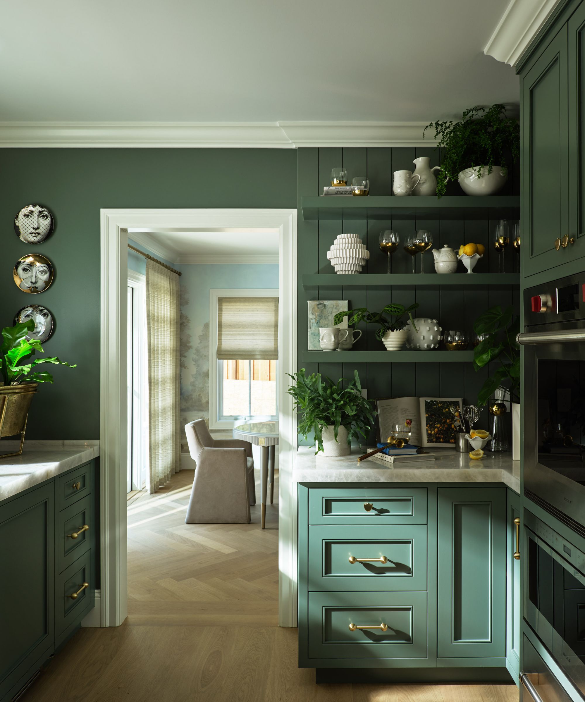 A green pantry with rustic decor.