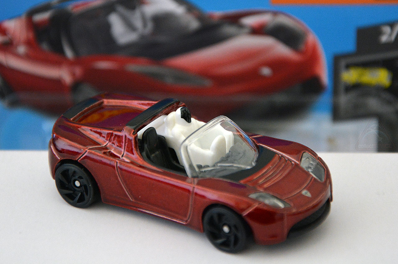 A Hot Wheels version of the Tesla roadster SpaceX launched into space, complete with a small mannequin in a spacesuit.