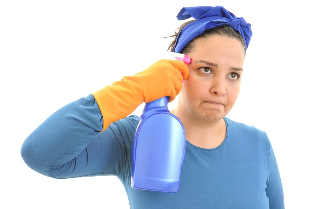 Woman shooting herself with spray cleaner.