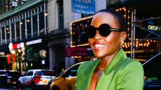 lupita nyong'o wearing a green suit 