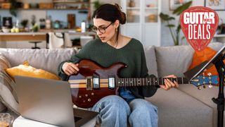 Female guitar teaches hosts an online lesson
