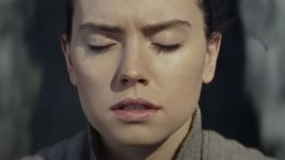 Daisy Ridley's Rey concentrating with her eyes closed in Star Wars: The Last Jedi