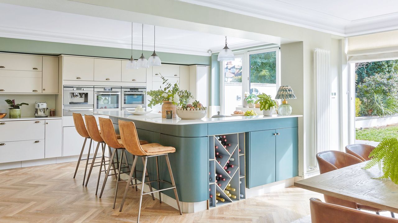 Green kitchen peninsula with glazed garden doors