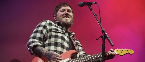 Brian Fallon onstage holding a guitar