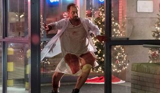 chris meloni in bloody hospital gown on happy