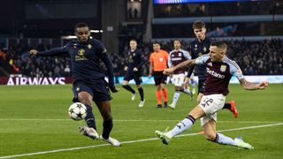 Aston Villa's Lucas Digne (right) crosses under pressure from Juventus' Pierre Kalulu during the UEFA Champions League 2024/25 League Phase MD5 match between Aston Villa FC and Juventus at Villa Park on November 27, 2024 in Birmingham, England.