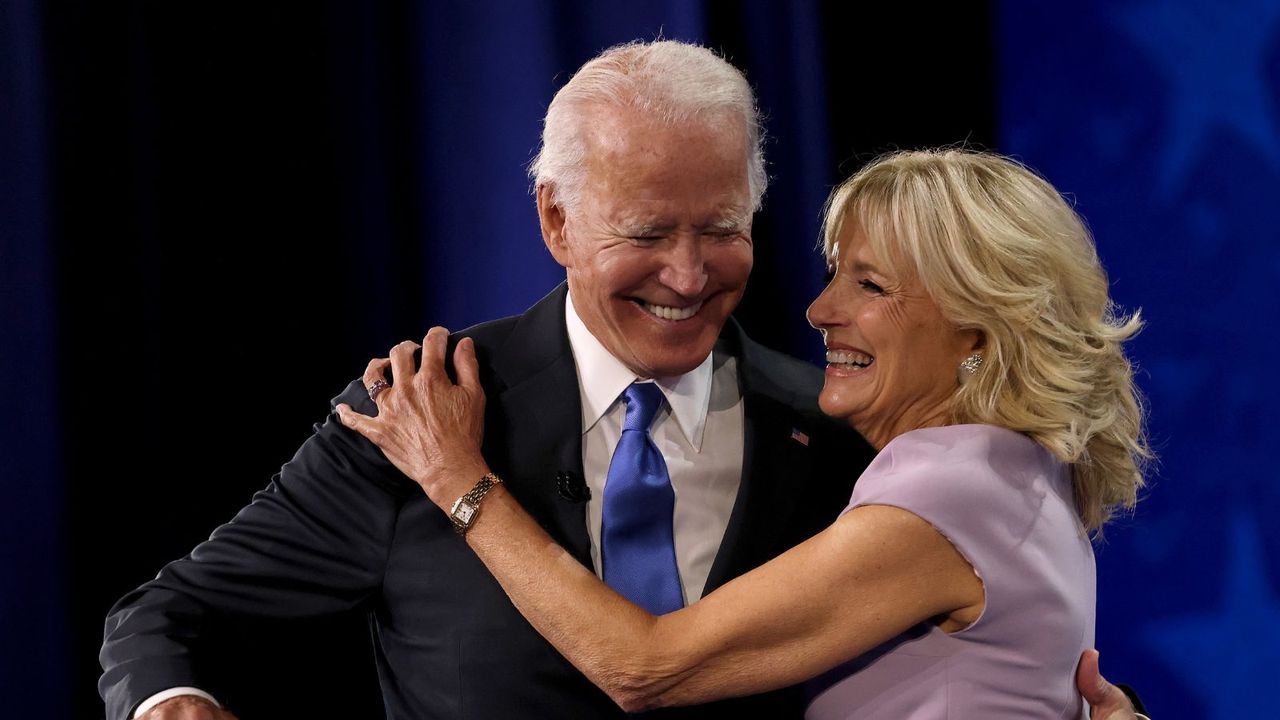 jill and joe biden hugging on a blue background