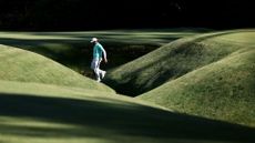 France's Matthieu Pavon walks over Rae's Creek on the 13th hole during the third round of the 2024 Masters Tournament at Augusta National Golf Club 