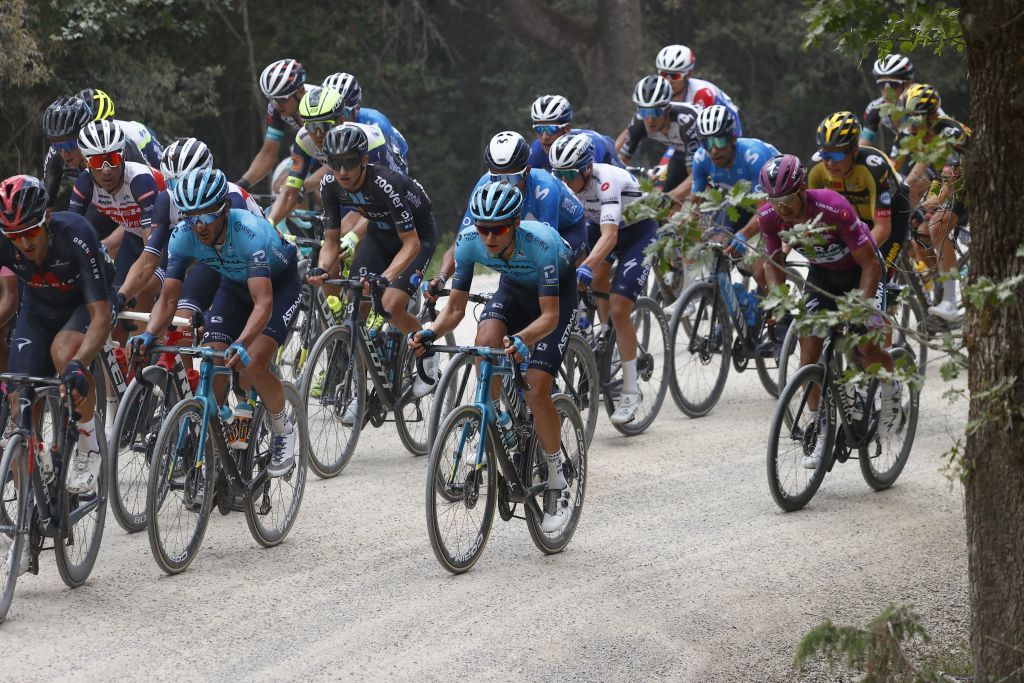 Team Astana rider Russias Aleksander Vlasov C rides in the pack during the eleventh stage of the Giro dItalia 2021 cycling race 162 km between Perugia and Montalcino on May 19 2021 Photo by Luca Bettini AFP Photo by LUCA BETTINIAFP via Getty Images