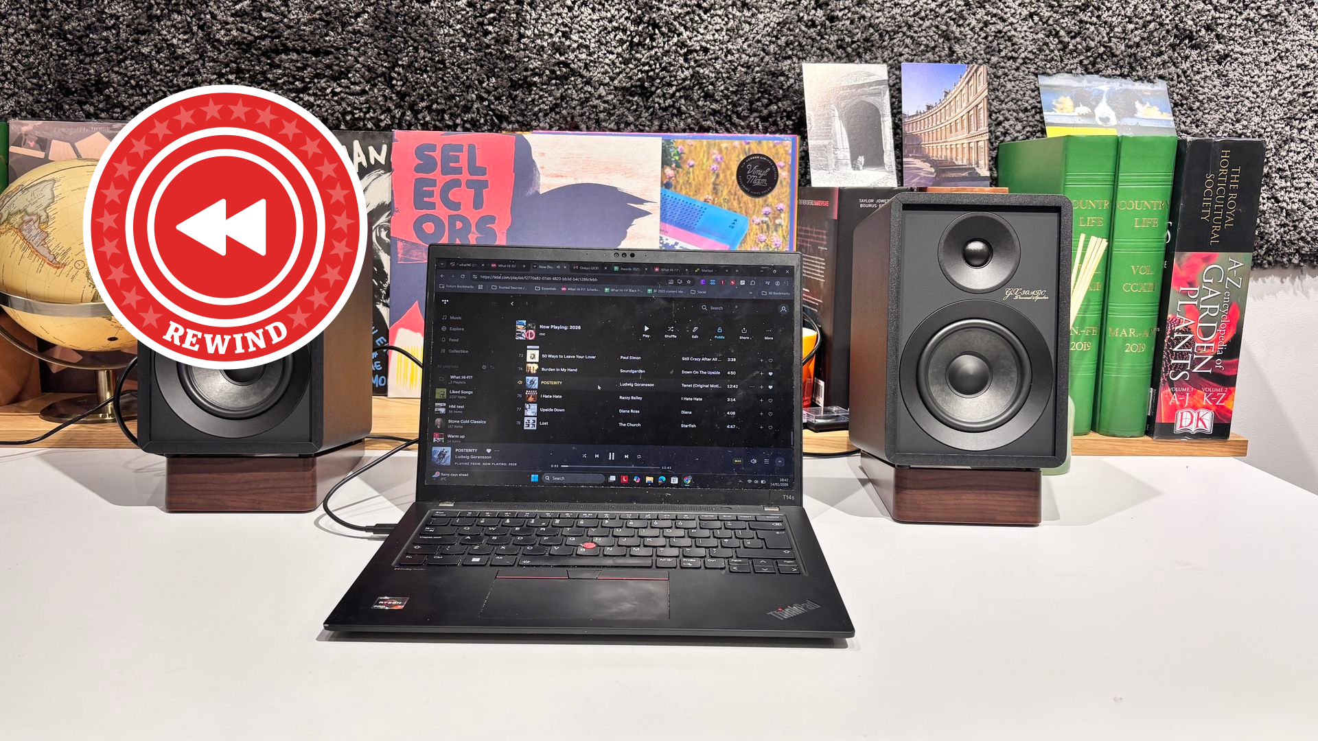 Onkyo speakers on desk with Rewind logo