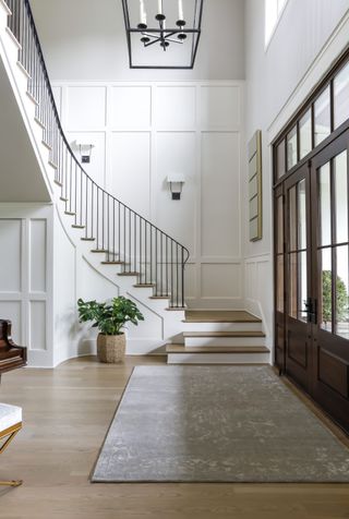 A staircase with an all white wall