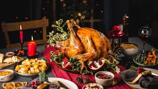 A table set for Christmas dinner with a roast turkey