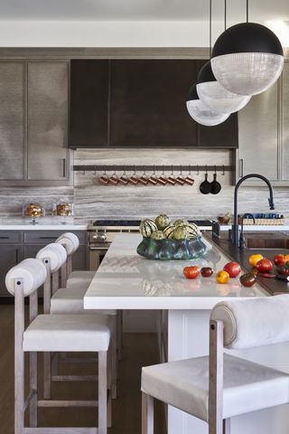 split-level kitchen island with marble and wood by Michelle Gerson Interiors