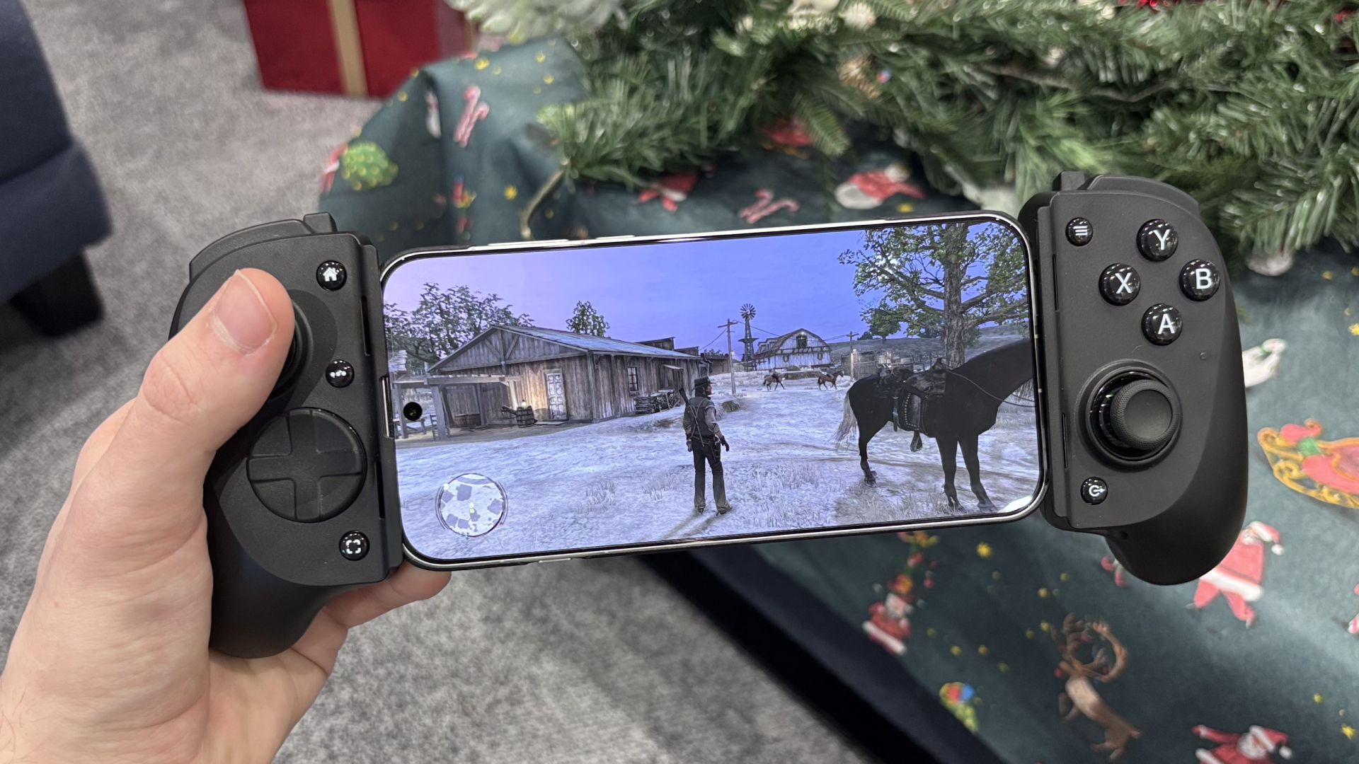 The Razer Kishi V3 Pro with a phone bracketed playing Red Dead Redemption