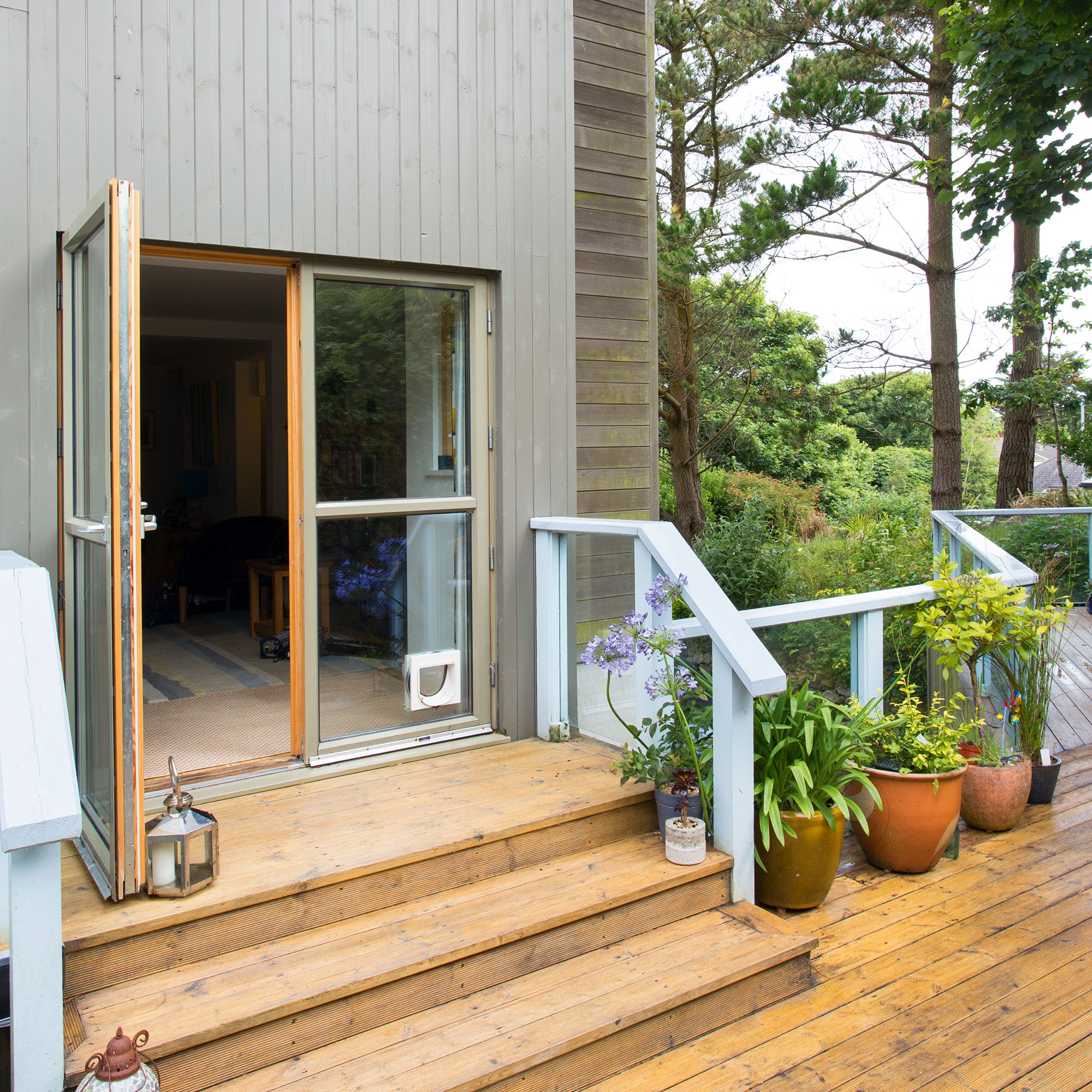 garden with wooden floor and potted plants