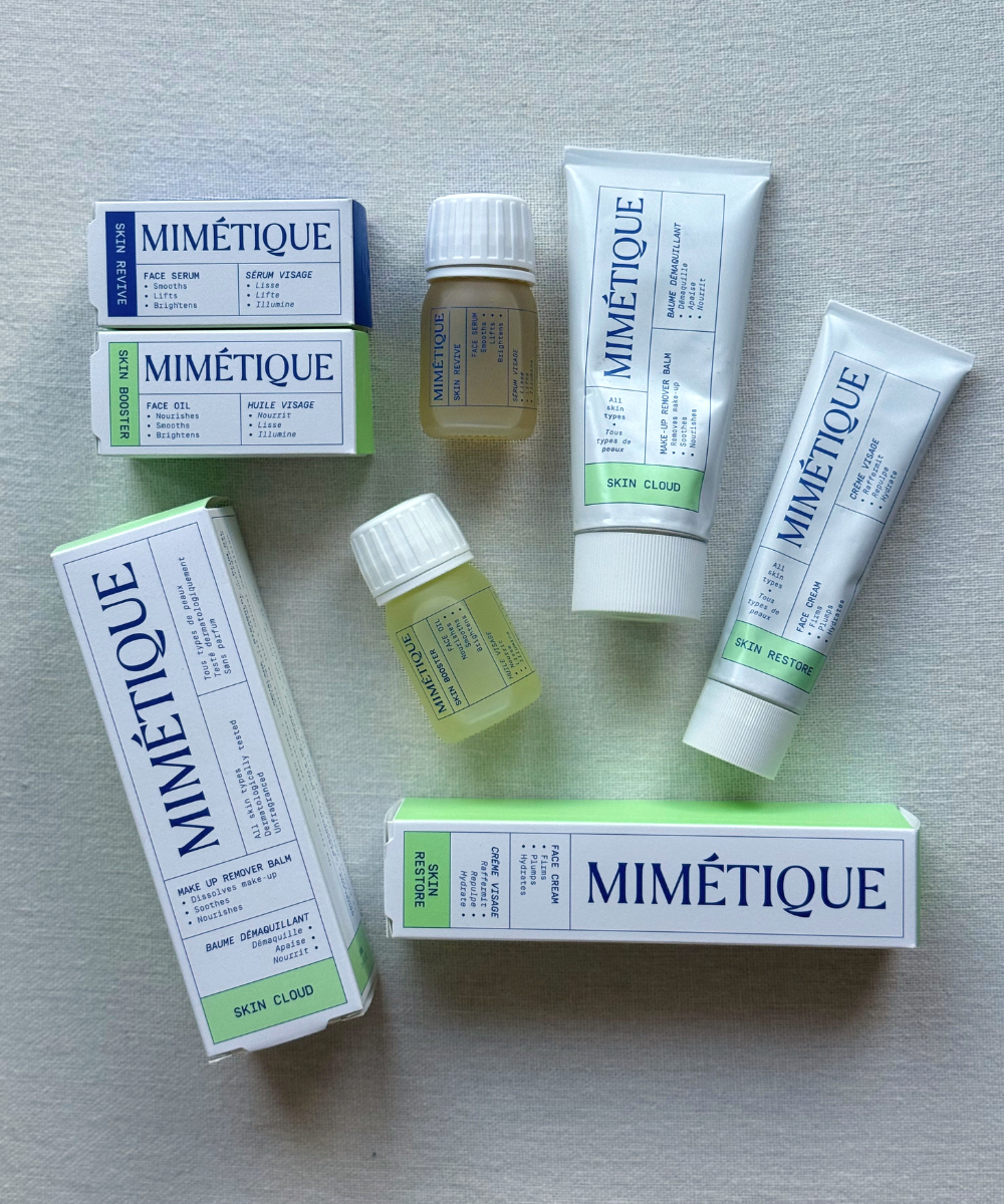 Bird's eye view of a flatlay of the Mimetique skincare range and each product's box