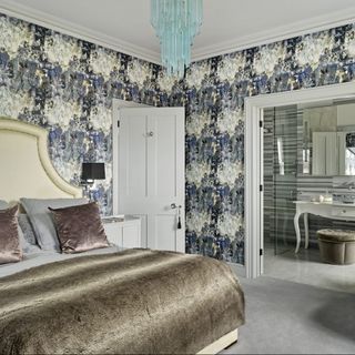 bedroom with printed wall and attached washroom