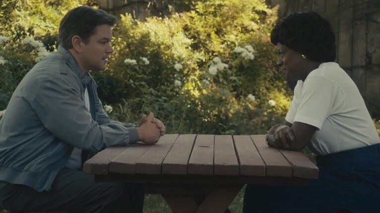 Matt Damon sits across from Viola Davis at a picnic table in AIR
