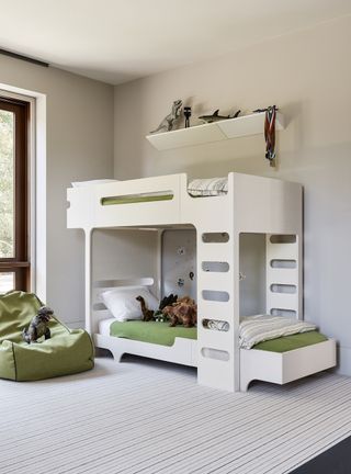White children's bedroom with bunk beds and green sheets