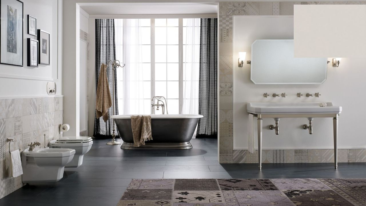 A large bathroom with a bath, toilet and bidet