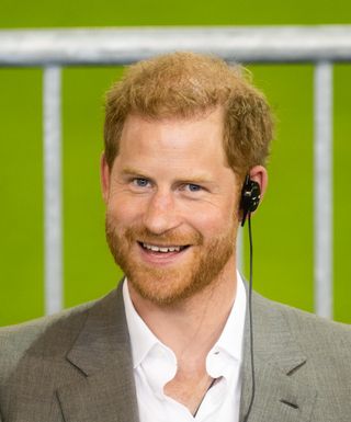 Prince Harry with an audio device on