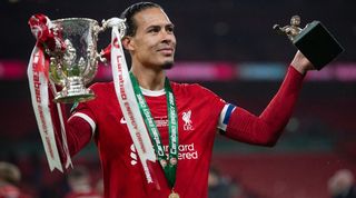 Virgil van Dijk celebrates with the Carabao Cup trophy and his Man of the Match award after Liverpool's win over Chelsea in February 2024.