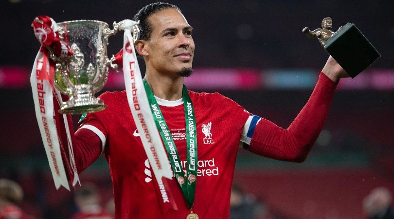 Virgil van Dijk celebrates with the Carabao Cup trophy and his Man of the Match award after Liverpool&#039;s win over Chelsea in February 2024.