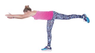 Woman doing warrior balance, one of the key moves in our 30-day flat stomach workout challenge
