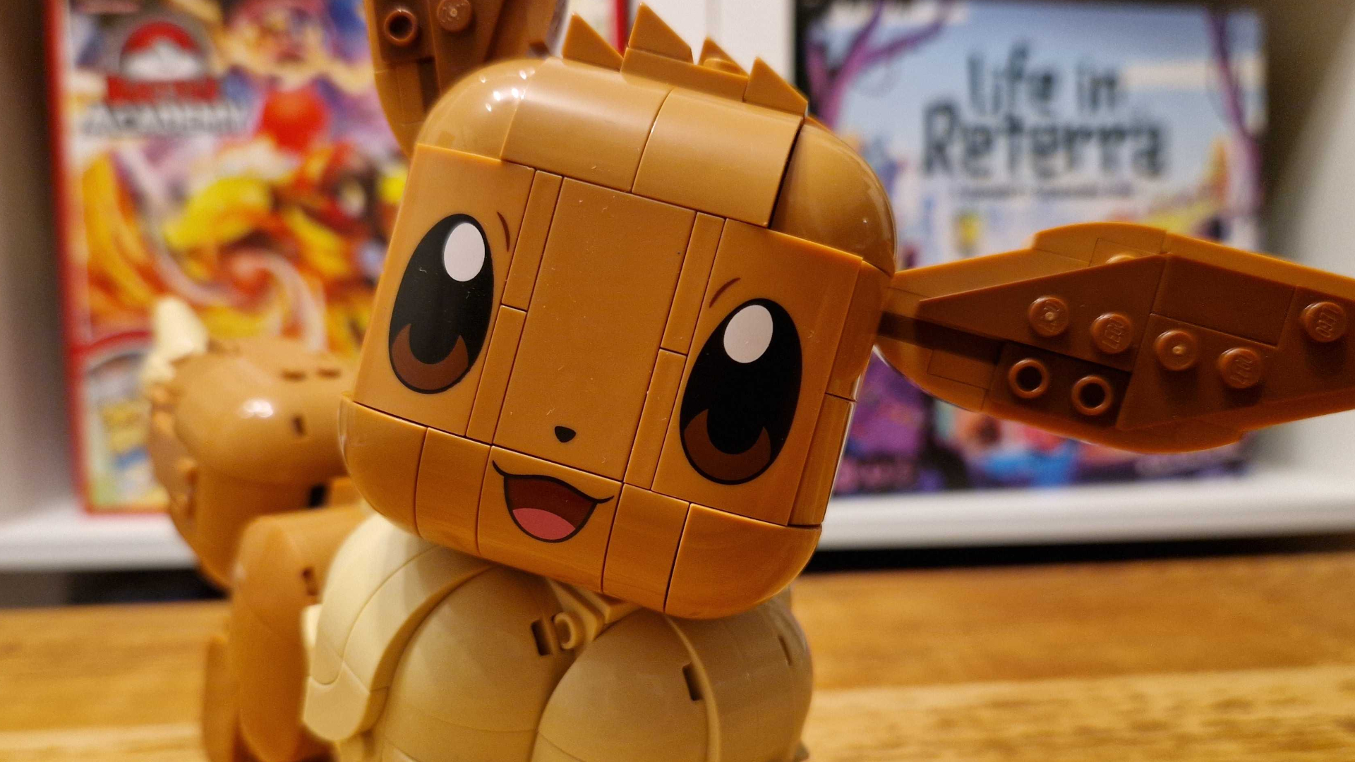 Lego Eevee model close to the foreground, with board games visible in the background