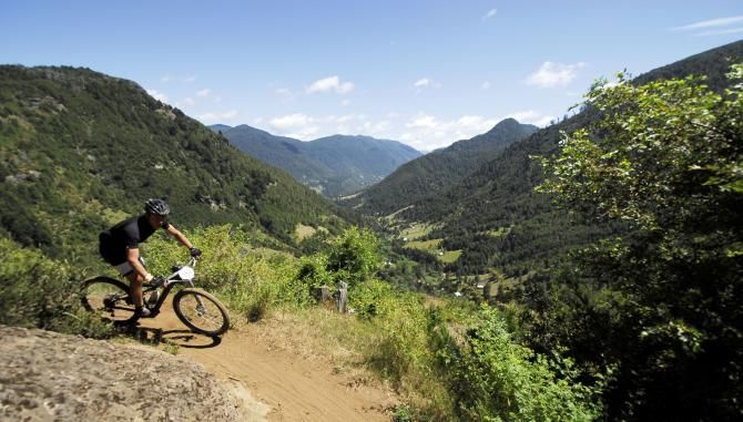 A rider flies downhill around a bend during stage 4 of the Trans Andes