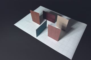 An arrangement of small samples of wood by Alpi and Piero Lissoni, in colours including pink, dark green, white, red and natural wood