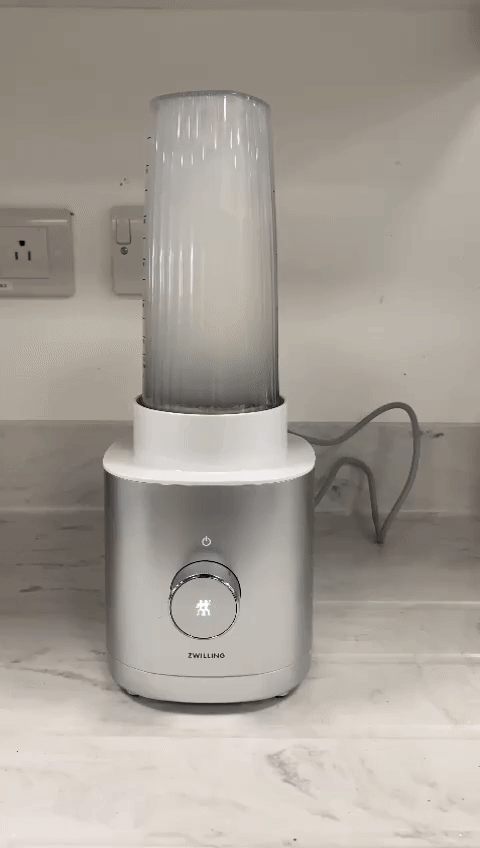 Blending a warm water and dish soap solution in the Zwilling personal blender