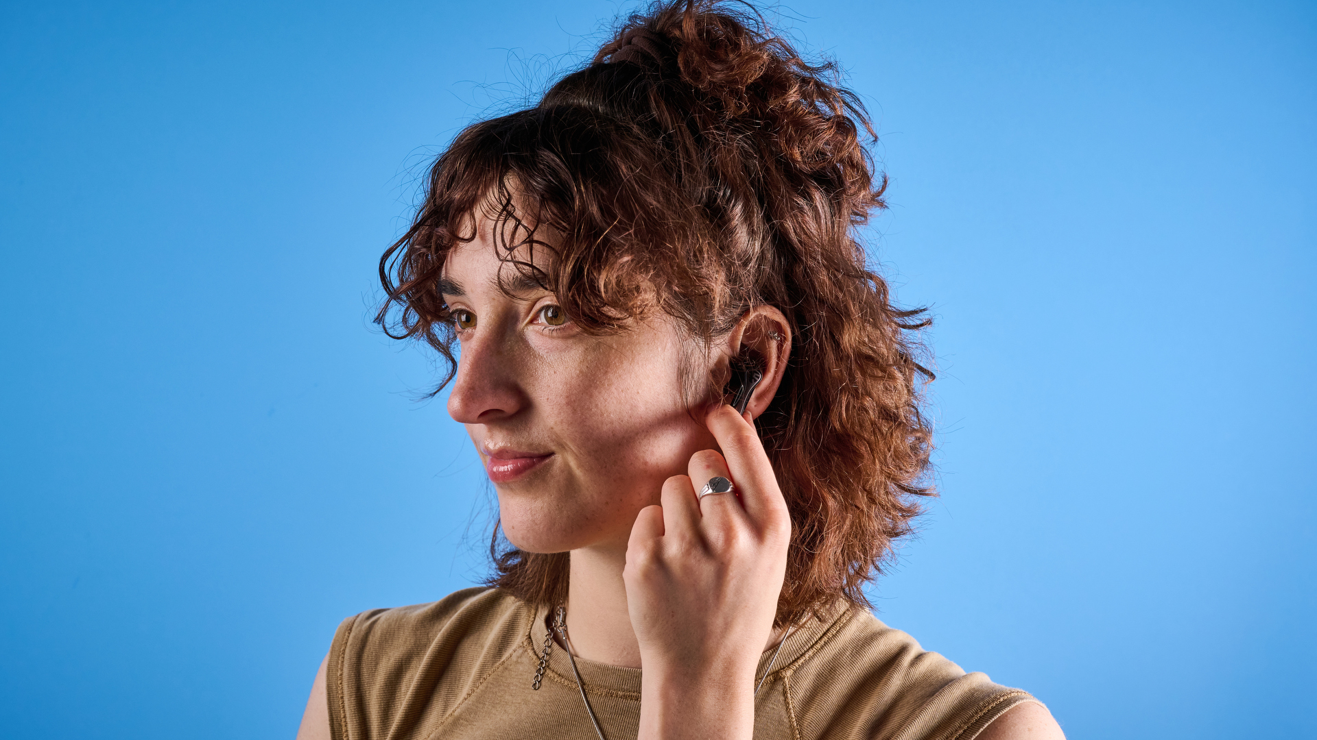 the soundpeats air5 pro earbuds in black and bronze with a black charging case and ear tips