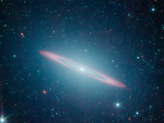 The infrared vision of NASA's Spitzer Space Telescope has revealed that the Sombrero galaxy -- named after its appearance in visible light to a wide-brimmed hat -- is in fact two galaxies in one. It is a large elliptical galaxy (blue-green) with a thin disk galaxy (partly seen in red) embedded within. Previous visible-light images led astronomers to believe the Sombrero was simply a regular flat disk galaxy.