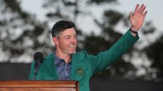 Rory McIlroy salutes the crowd wearing his green jacket