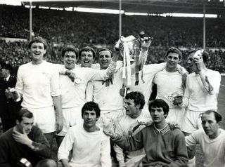 Queens Park Rangers players celebrate with the League Cup with their captain Mike Keen