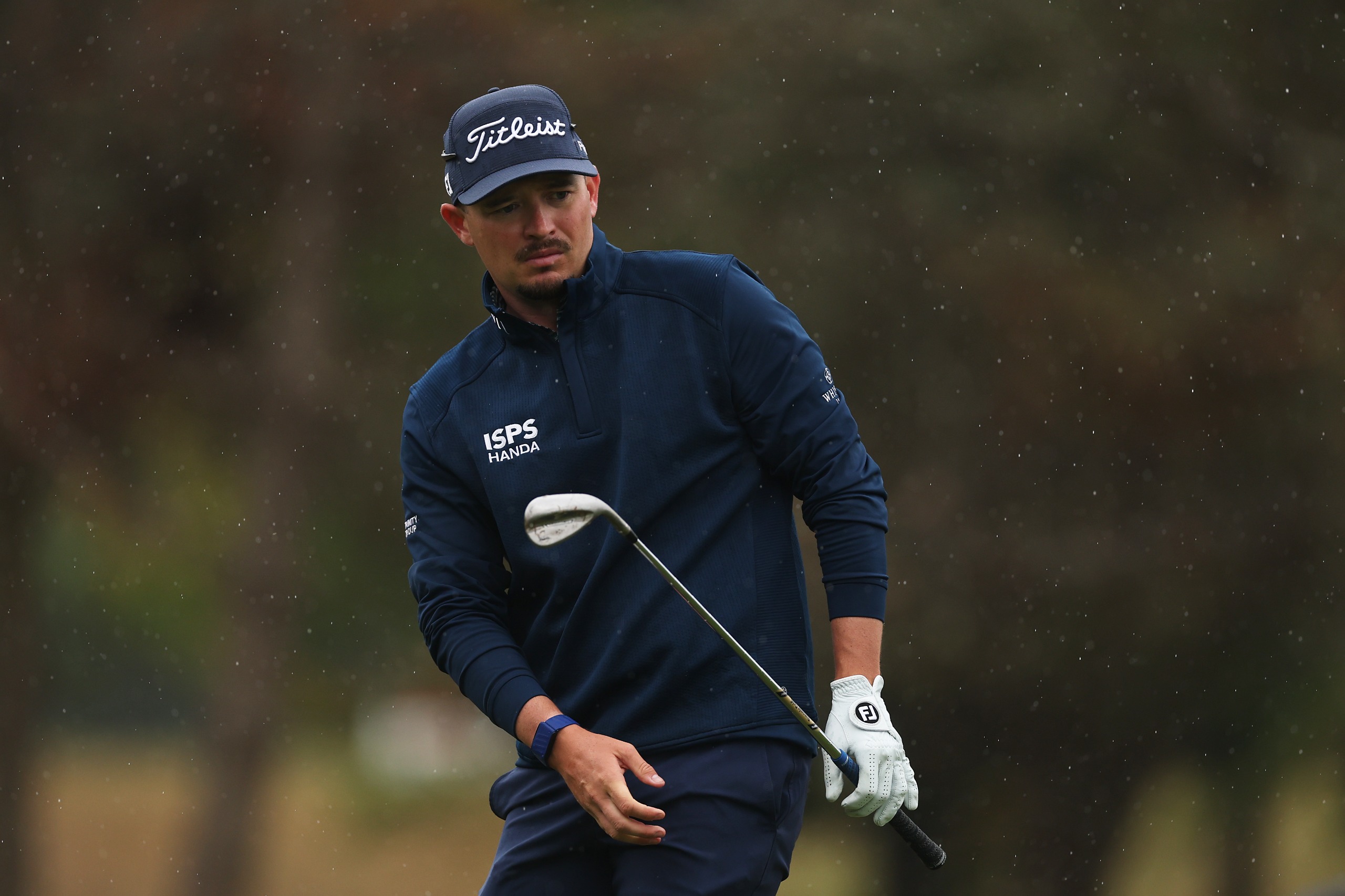 Ewen Ferguson watching his chip shot with a wedge in hand
